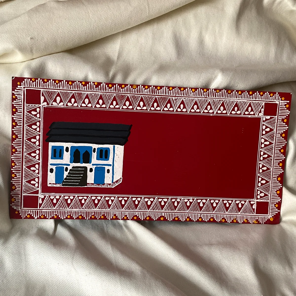 Pahadi home nameplate with a painted village house
